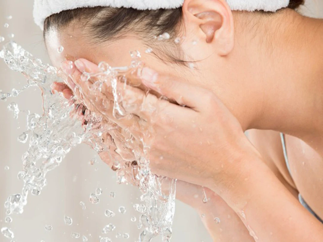 Splashing clean water on the face — for dry or sensitive skin, a water-only rinse in the morning can be enough if you cleansed thoroughly the night before