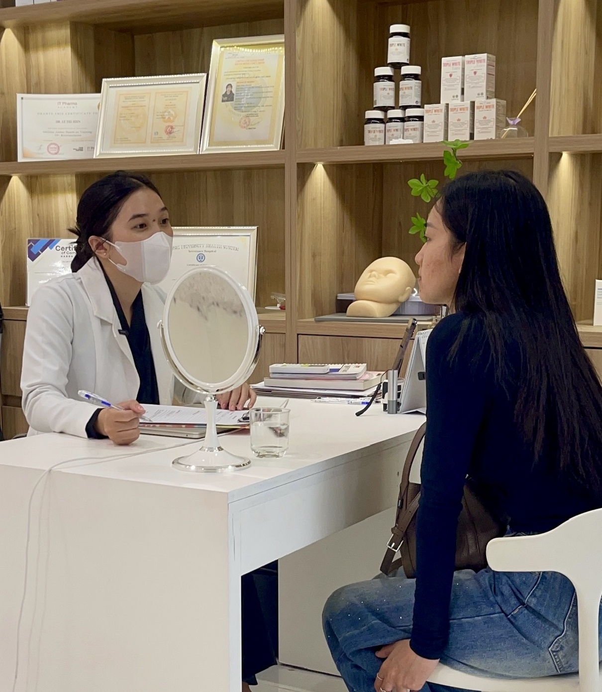 A client receiving a dermatology consultation at Eternal Beauty Center